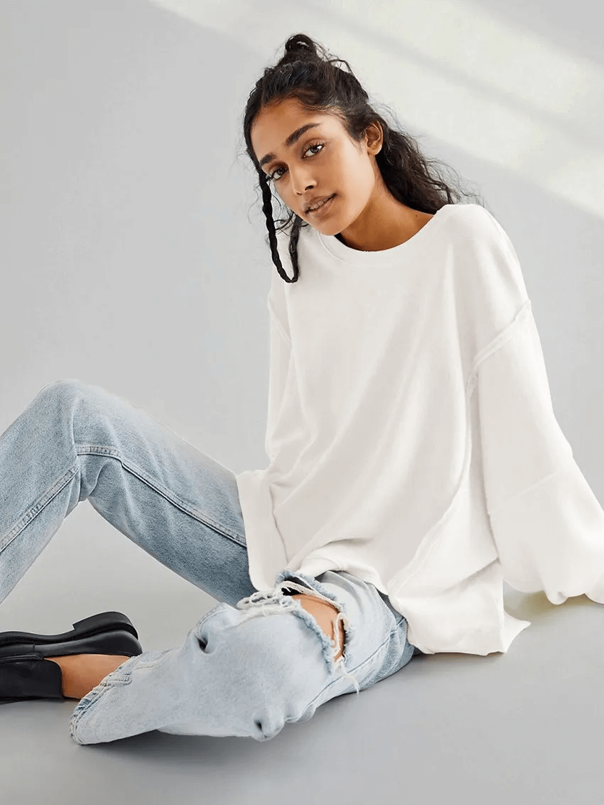Woman wearing a solid color drop shoulder loose sweatshirt with O-Neck and three-quarter sleeves